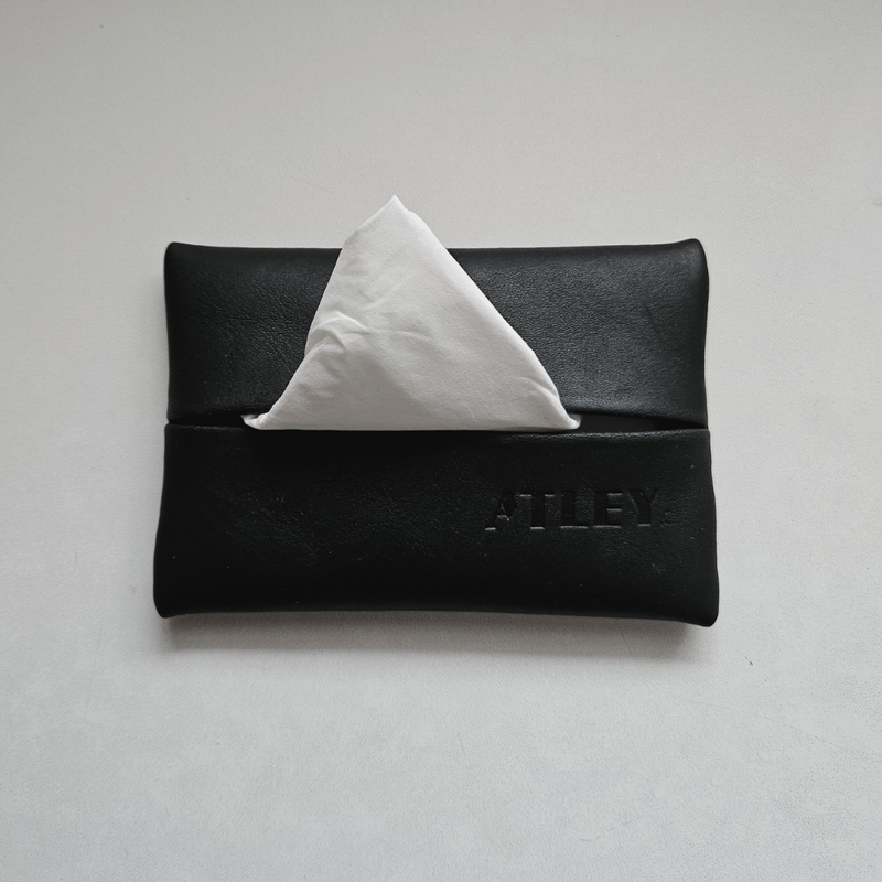 Black leather tissue holder with a white tissues travel pouch