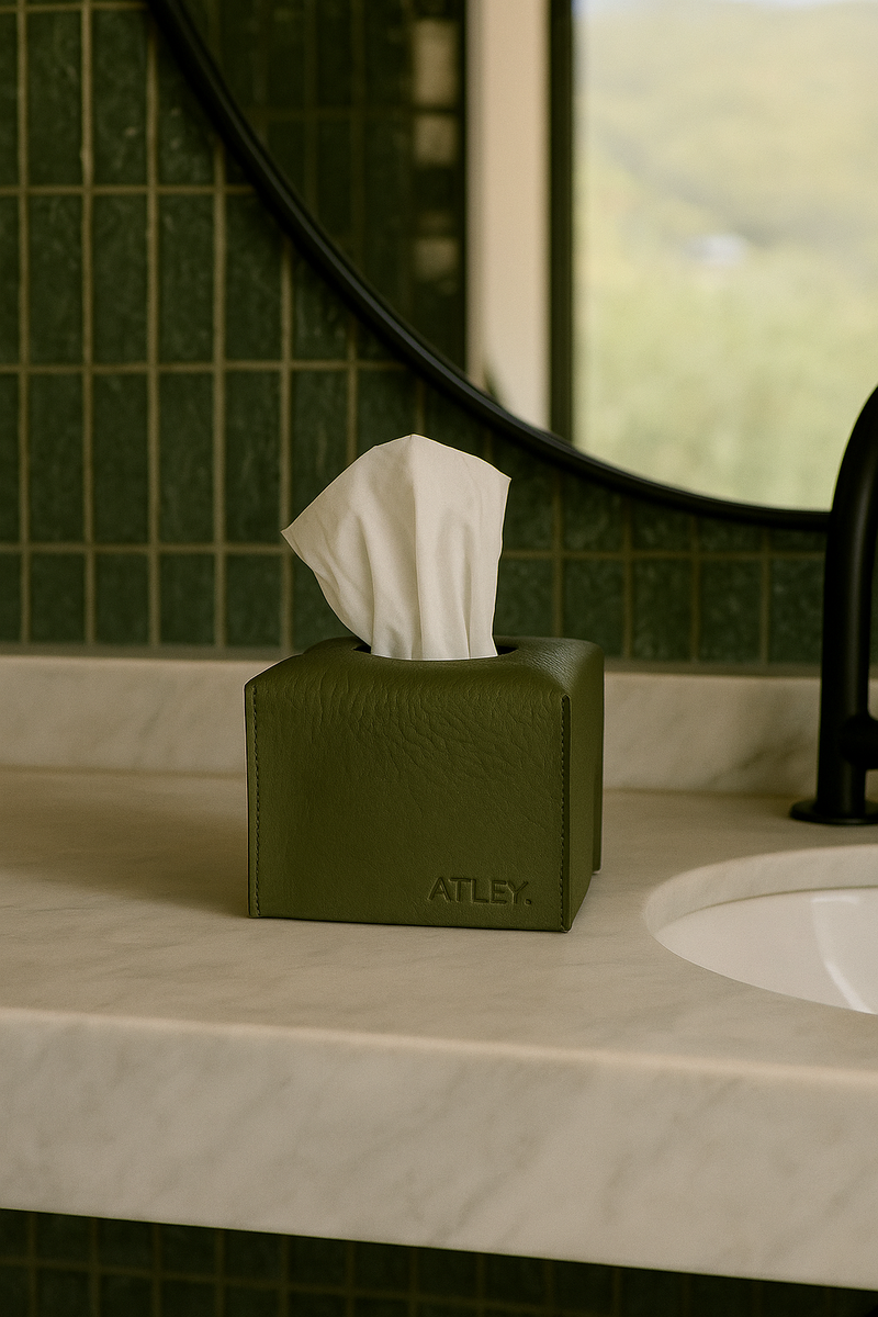 Green tissue box with tissues on a bathroom counter